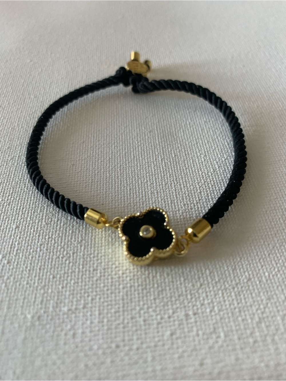 Elegant Black Clover Cord Bracelet with Gold Accents